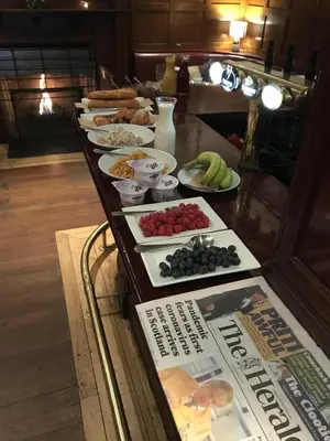 a buffet with plates of food and a newspaper at Babbity Bowsters in Glasgow
