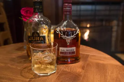 two bottles of alcohol and a glass on a table at Babbity Bowsters in Glasgow