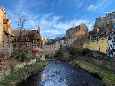 a river in the middle of a city with buildings at Stylish & Charming Retreat for 2- City Centre! - Pass the Keys in Edinburgh