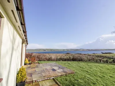 a view from the porch of a house with a view of the water at Ettrick Cottage in Port Bannatyne