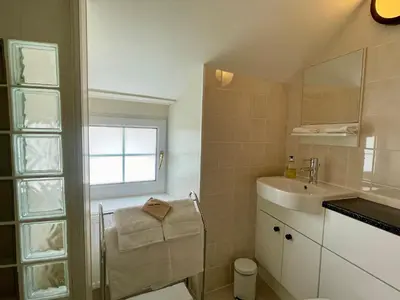 a bathroom with a sink and a toilet and a window at TwoStones Self Catering Cottage in Arrochar