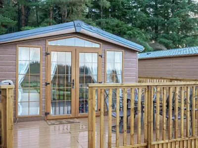 a gazebo with a glass door on a deck at The Orchard - Uk7111 in Alloa
