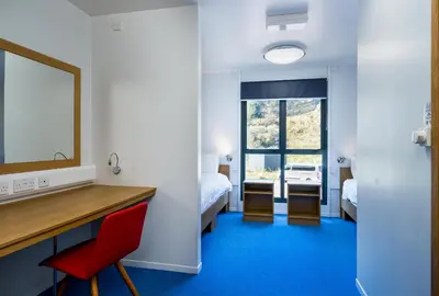 a room with a desk and a red chair at FSC Millport Hostel in Millport