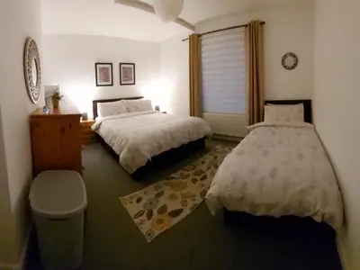 a bedroom with two beds and a window at LAWFIELD R&R in West Kilbride