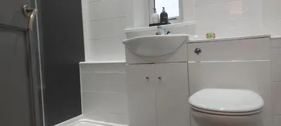 a white bathroom with a sink and a toilet at LAWFIELD R&R in West Kilbride