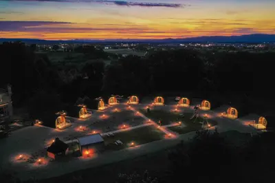 an aerial view of a house with lights at night at Weedingshall Lodges in Falkirk