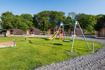 a playground with a slide in a park at Weedingshall Lodges in Falkirk