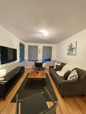 a living room with a couch and a flat screen tv at Bijou Merchant City Apartment with Parking (Albion 1) in Glasgow