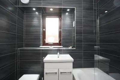 a bathroom with a sink and a toilet and a window at Bijou Merchant City Apartment with Parking (Albion 1) in Glasgow