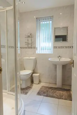 a bathroom with a toilet and a sink and a shower at Clyde View B&B in Dunoon
