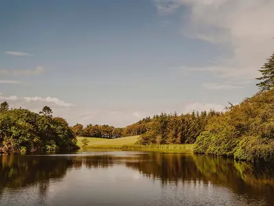 a river with trees on the side of it at Wild Geese Lodge - Uk31046 in Portpatrick