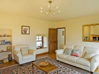 a living room with two white couches and a table at The Bothy in Haywood