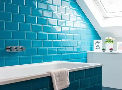a bathroom with blue subway tiles and a tub at City Centre, Newly Refurbished Stylish Apartment in Edinburgh