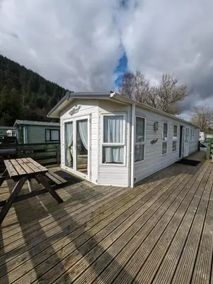 a white tiny house on a wooden deck at The Ashcroft Sea View 6 in Dunoon