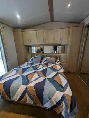 a bedroom with a bed with a colorful comforter at The Ashcroft Sea View 6 in Dunoon
