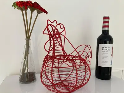 a bottle of wine next to a vase with flowers at Lochay Lodges in Killin