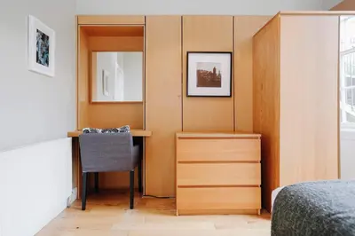 a bedroom with a dressing table and a mirror at JOIVY Lovely Flat in the Heart of Edinburgh in Edinburgh