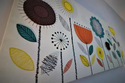 a painting of flowers on a wall at Signature - Moss View in Govan
