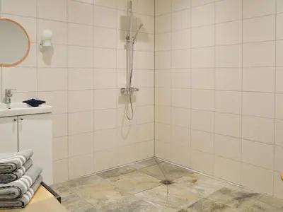 a bathroom with a shower and a sink at Printmakers Cottage in Bellanoch