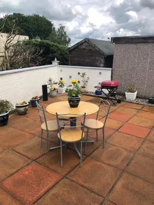 a patio with a table and chairs and a fence at Limegrove Comfortable three bedroom house in Law