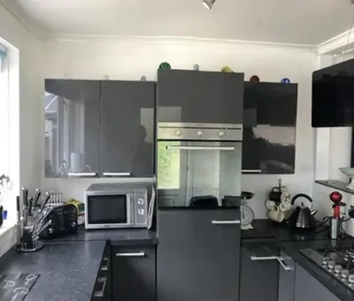 a kitchen with a refrigerator and a microwave at Limegrove Comfortable three bedroom house in Law