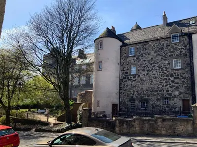 a car parked in front of a stone building at Old Spittal Hospital Apartment - Free Parking in Stirling