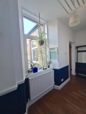 an empty room with a window and plants on a radiator at The Editor's Choice, Oban seafront apartment in Oban