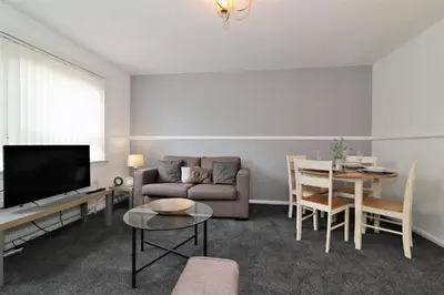 a living room with a couch and a table at Signature - Troon View in East Kilbride