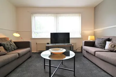 a living room with two couches and a coffee table at Signature - Troon View in East Kilbride