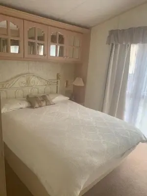 a bedroom with a white bed and a window at Lyndhurst Corner 72 in Dunoon