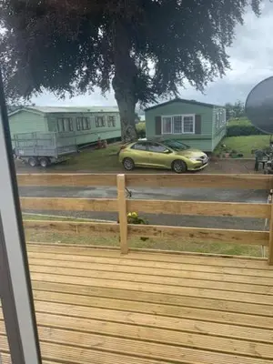 a yellow car parked in front of a house at Lyndhurst Corner 72 in Dunoon