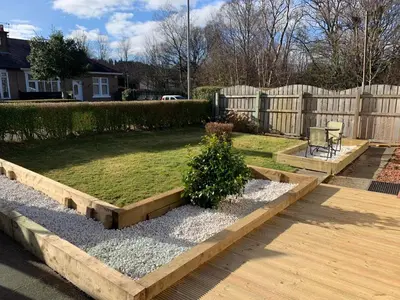 a backyard with a garden with a wooden fence at Nairoo in Balloch