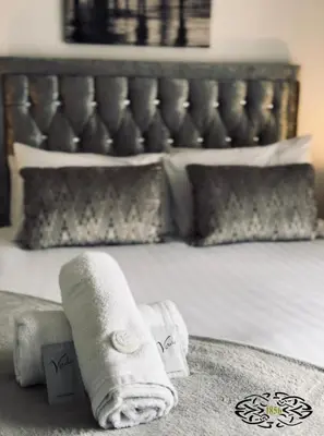 a hotel room with a towel on a bed at Royal Marine Hotel Dunoon in Kirn