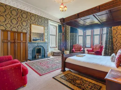 a bedroom with a bed and a fireplace at The Old Nunnery - Uk7122 in Skelmorlie
