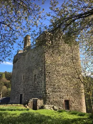 an old stone building on a lush green field at Queen Mary's Chamber in Peebles