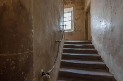 a staircase in an old building with a window at Queen Mary's Chamber in Peebles