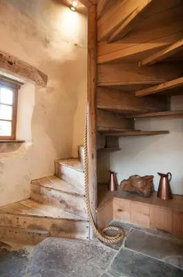 a staircase in a room with wooden ceilings at Barns Tower in Peebles
