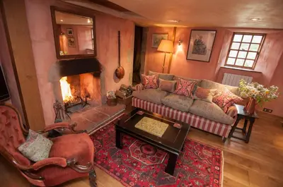 a living room with a couch and a fireplace at Barns Tower in Peebles