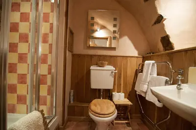 a bathroom with a toilet and a sink at Barns Tower in Peebles