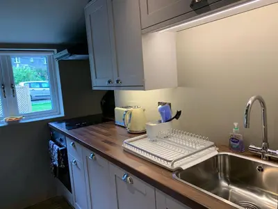 a kitchen counter with a keyboard and a sink at Barns Library in Peebles