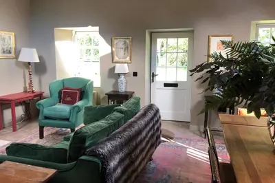 a living room with a couch and a chair at Barns Library in Peebles
