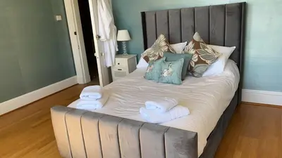 a large bed with towels on it in a bedroom at Ardmor Guest House in Oban
