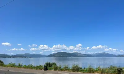 a view of a lake with mountains in the background at The Wee Cottage by the Ferry in Gourock