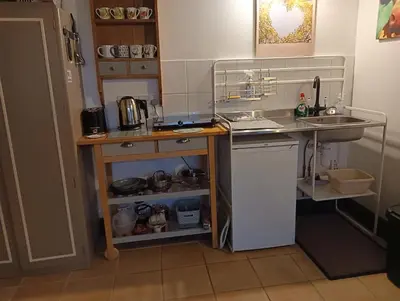 a small kitchen with a sink and a counter at The Bothy Claymires Loch Lomond & Stirling in Buchlyvie