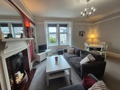 a living room with a couch and a fireplace at Brae View Coastal Gem in Largs