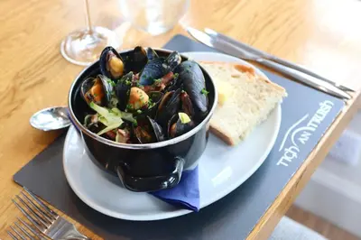 a plate of food with a bowl of mussels and bread at Tigh an Truish Inn in Oban