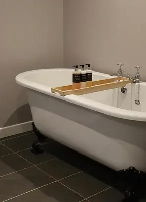 a white bath tub with three bottles on it at Tigh an Truish Inn in Oban