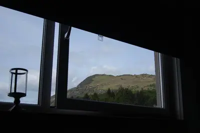 a window with a view of a mountain view at Creag Mhor Self Catering Holiday Apartment in Aberfoyle