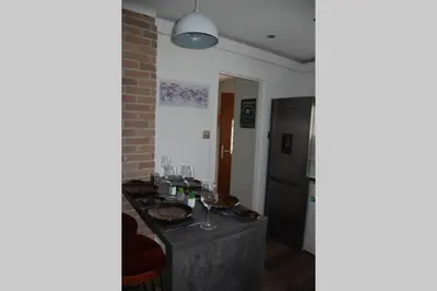 a kitchen with a table with food and wine glasses at Creag Mhor Self Catering Holiday Apartment in Aberfoyle