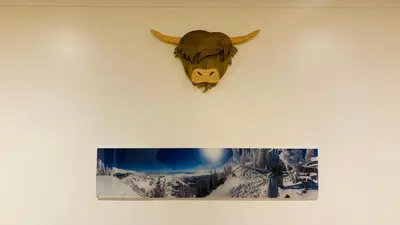 a picture of a bull hanging on a wall at Park side Cottage, Number 2, The Morays in Blackford